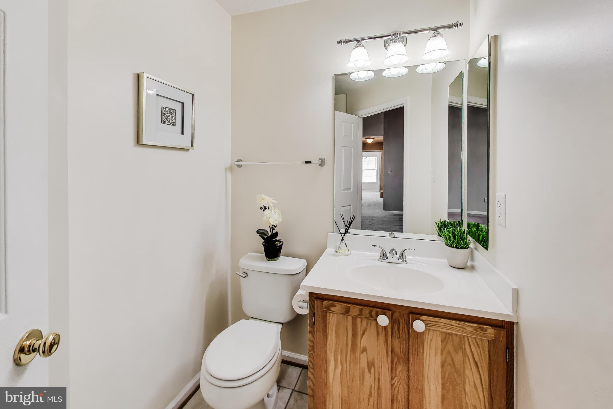 687 Winding Stream Way, Unit 304 Odenton, MD 21113 - Photo 17 of 33 a bathroom with a sink vanity mirror and toilet