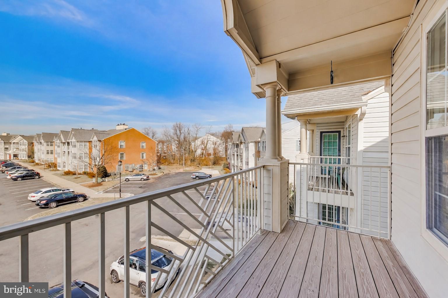 687 Winding Stream Way, Unit 304 Odenton, MD 21113 - Photo 19 of 33 a view of a balcony with wooden floor