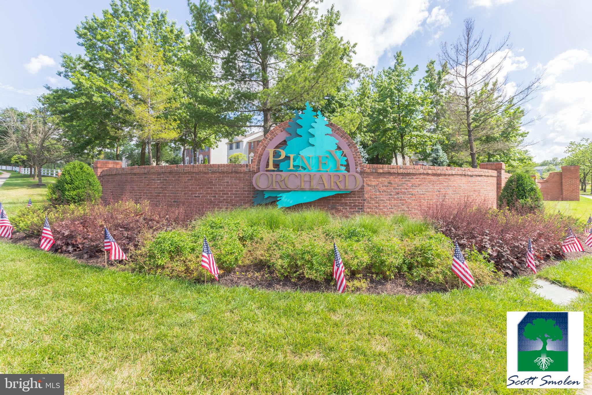 687 Winding Stream Way, Unit 304 Odenton, MD 21113 - Photo 20 of 33 a view of yard with flowers and trees