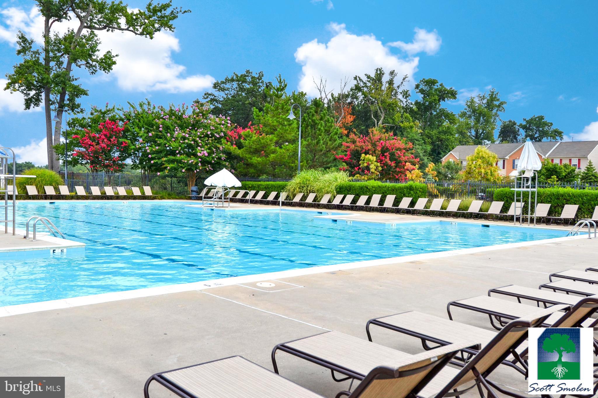 687 Winding Stream Way, Unit 304 Odenton, MD 21113 - Photo 26 of 33 a view of a chairs and table in a backyard