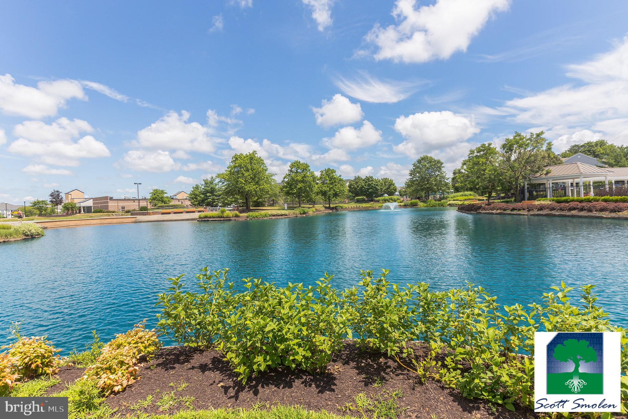 687 Winding Stream Way, Unit 304 Odenton, MD 21113 - Photo 27 of 33 a view of a lake with a house in the background