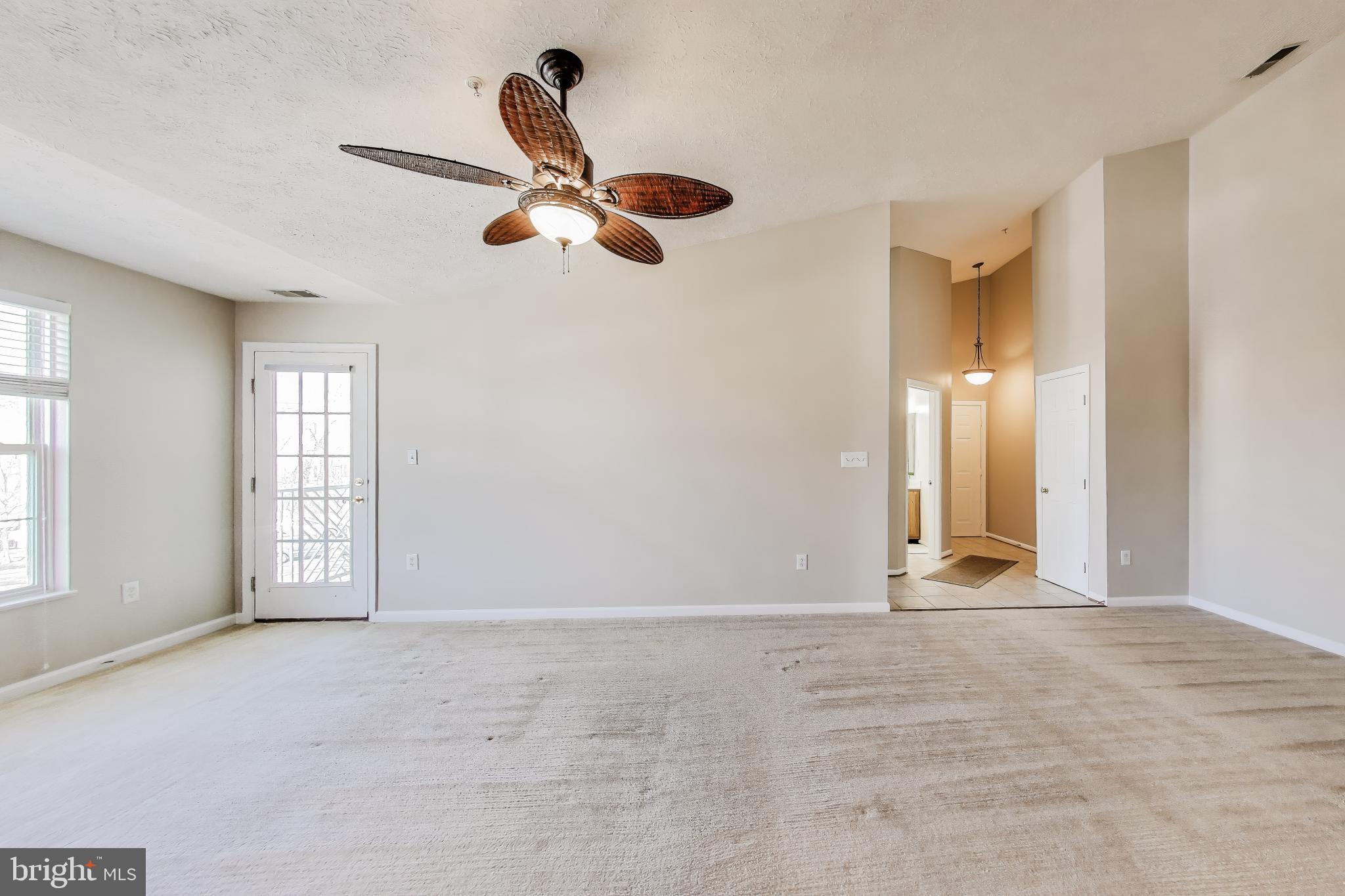 687 Winding Stream Way, Unit 304 Odenton, MD 21113 - Photo 7 of 33 an empty room with windows and fan