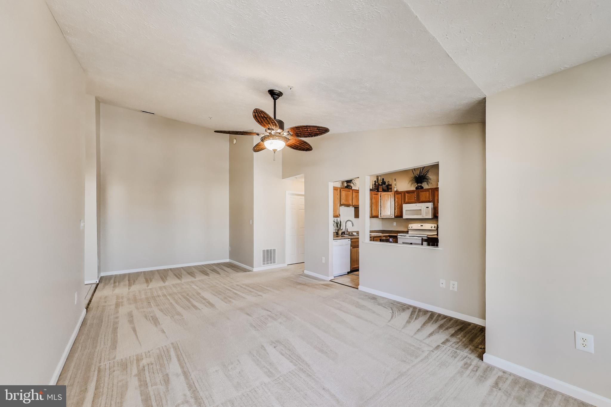 687 Winding Stream Way, Unit 304 Odenton, MD 21113 - Photo 8 of 33 a view of a room with a stylish ceiling fan and entryway