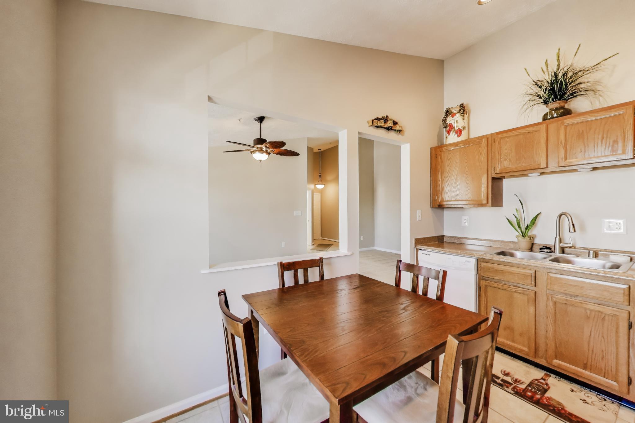 687 Winding Stream Way, Unit 304 Odenton, MD 21113 - Photo 10 of 33 a view of a dining room with furniture