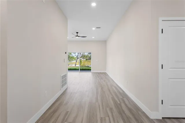 a view of an empty room and wooden floor