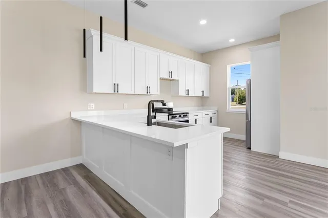 a kitchen with granite countertop white cabinets and white appliances