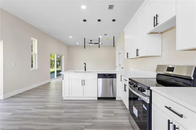 a kitchen with stove top oven and cabinets