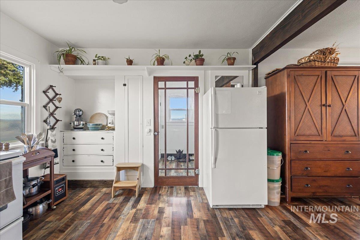 19454 Idaho Road Worley, ID 83876 - Photo 12 of 50 Kitchen with white appliances and dark wood-type flooring