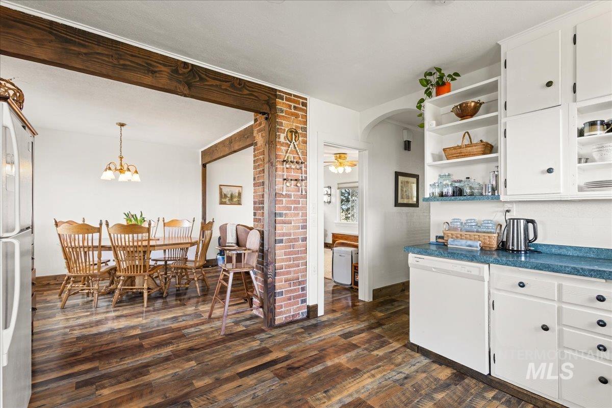 19454 Idaho Road Worley, ID 83876 - Photo 13 of 50 Kitchen featuring white appliances, arched walkways, open shelves, and white cabinets
