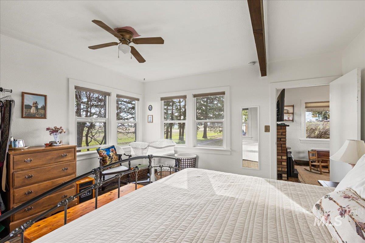 19454 Idaho Road Worley, ID 83876 - Photo 17 of 50 Bedroom with wood finished floors, ceiling fan, and beamed ceiling