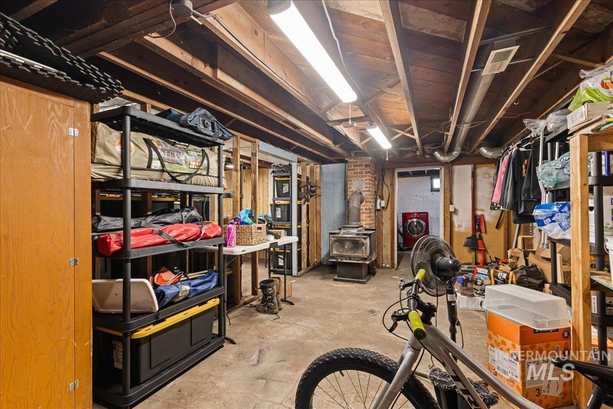 19454 Idaho Road Worley, ID 83876 - Photo 24 of 50 Unfinished basement with washer / dryer and a wood stove