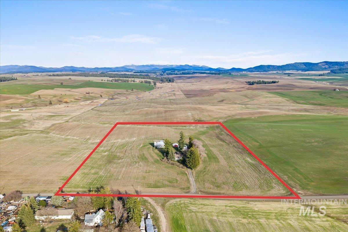 19454 Idaho Road Worley, ID 83876 - Photo 31 of 50 Overview of rural landscape featuring property boundaries highlighted and a mountain backdrop