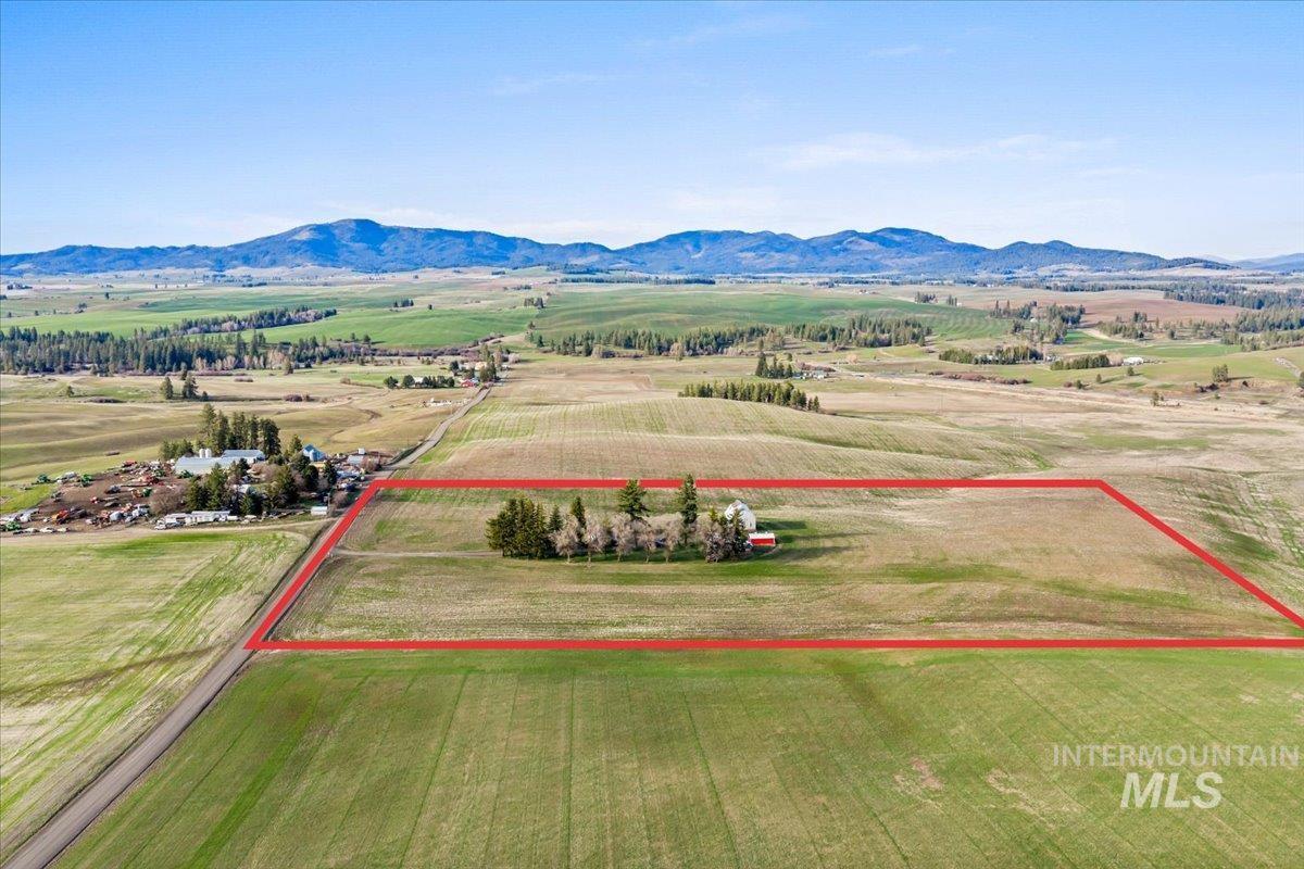 19454 Idaho Road Worley, ID 83876 - Photo 33 of 50 Aerial view of sparsely populated area featuring property boundaries highlighted and a mountainous background