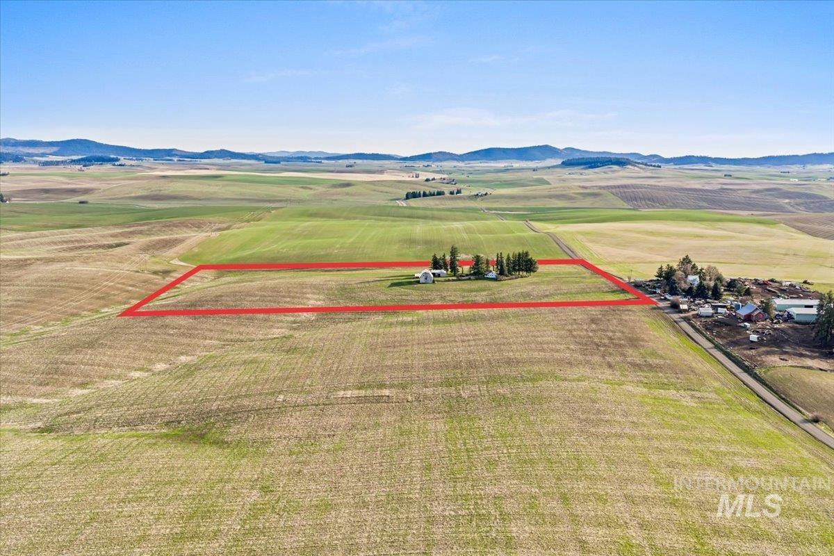 19454 Idaho Road Worley, ID 83876 - Photo 37 of 50 View of rural area featuring farmland, a mountainous background, and property parcel outlined