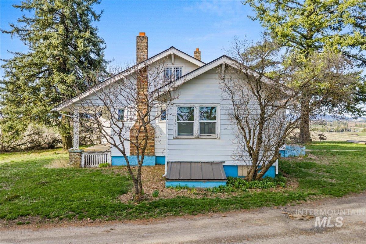 19454 Idaho Road Worley, ID 83876 - Photo 4 of 50 View of side of property with a chimney and a yard