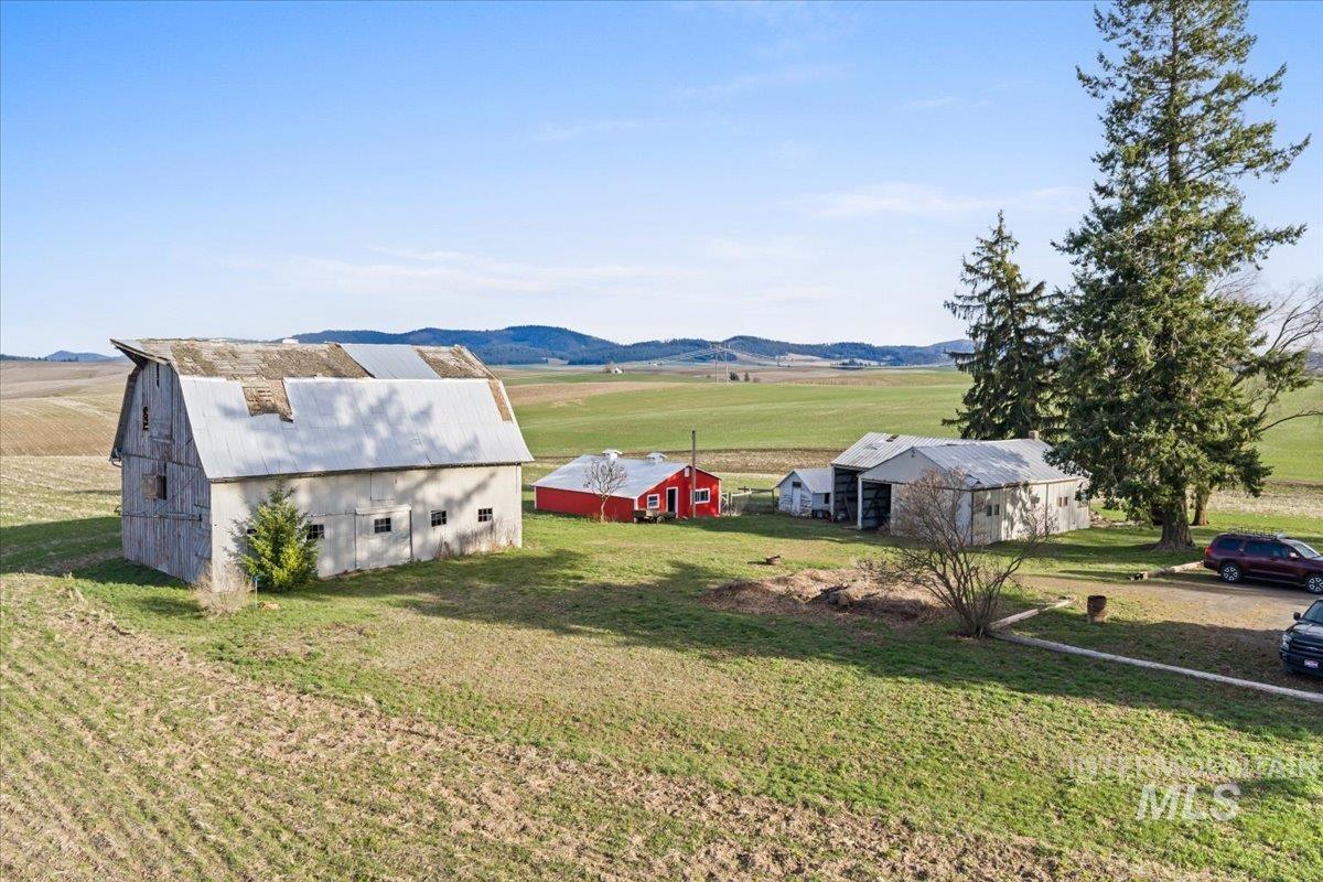 19454 Idaho Road Worley, ID 83876 - Photo 41 of 50 View of grassy yard featuring a view of rural / pastoral area, an outbuilding, and a mountain view