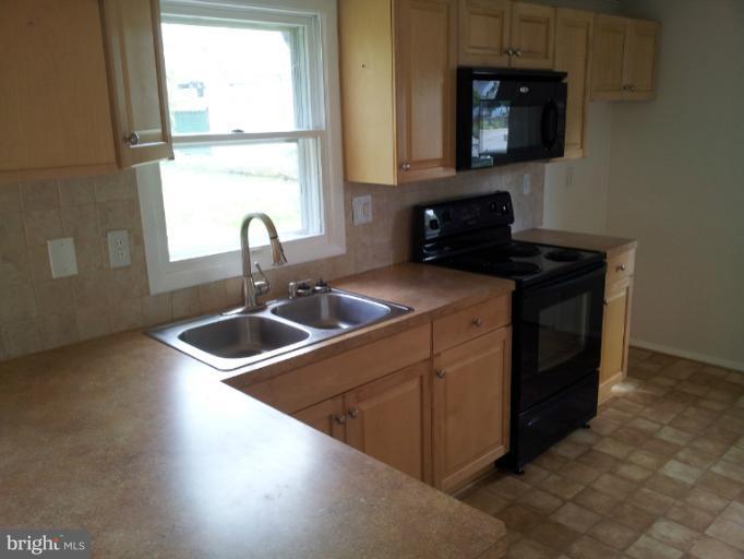 308 West 6th Avenue Ranson, WV 25438 - Photo 4 of 7 a kitchen with a sink stove and microwave