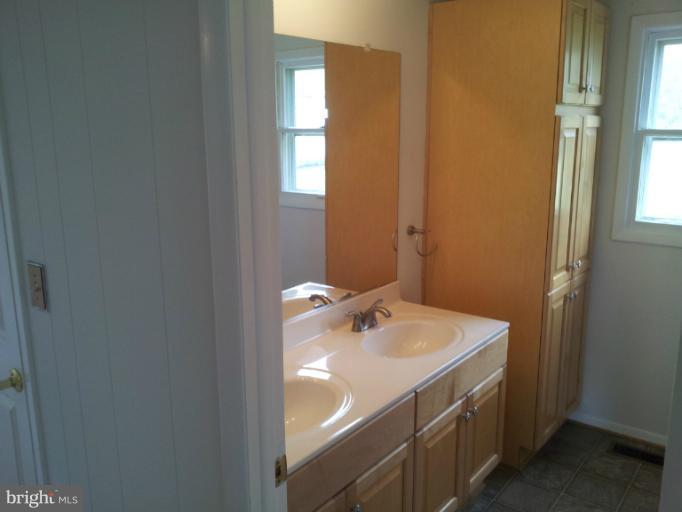 308 West 6th Avenue Ranson, WV 25438 - Photo 6 of 7 a bathroom with a sink and a mirror