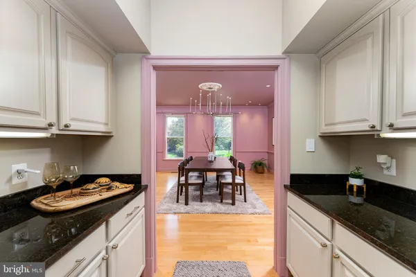 a kitchen with stainless steel appliances granite countertop a stove and a white cabinets