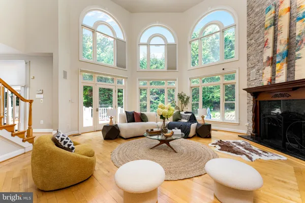 a living room with furniture fireplace and a large window