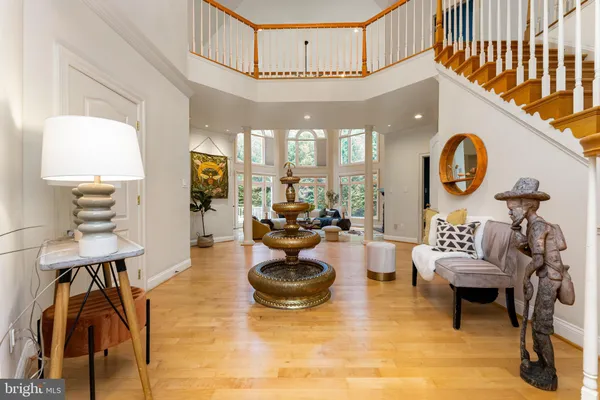 a living room with furniture a clock and a chandelier