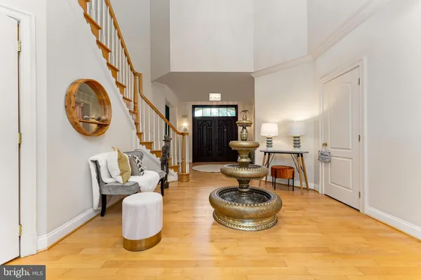 a living room with dining table and a large window