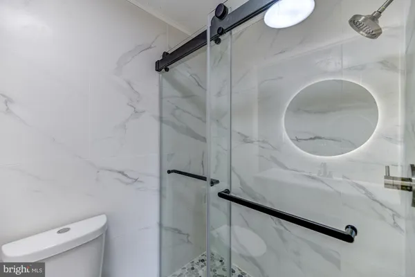 a bathroom with a toilet and a shower
