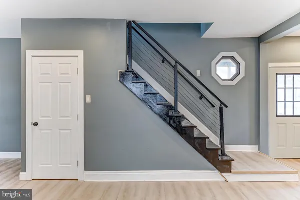 a view of entryway and hall with wooden floor
