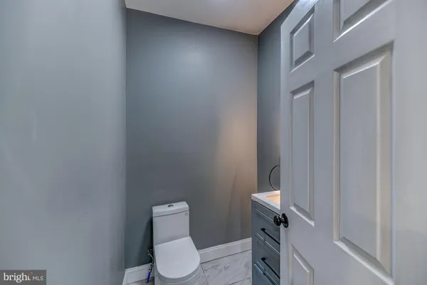 a white toilet sitting next to a shower
