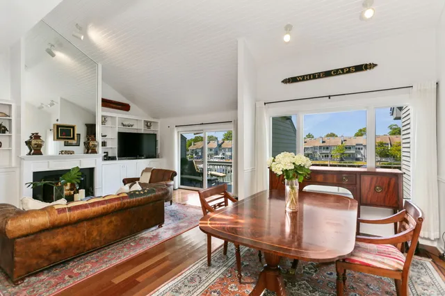 a living room with fireplace furniture and a large window