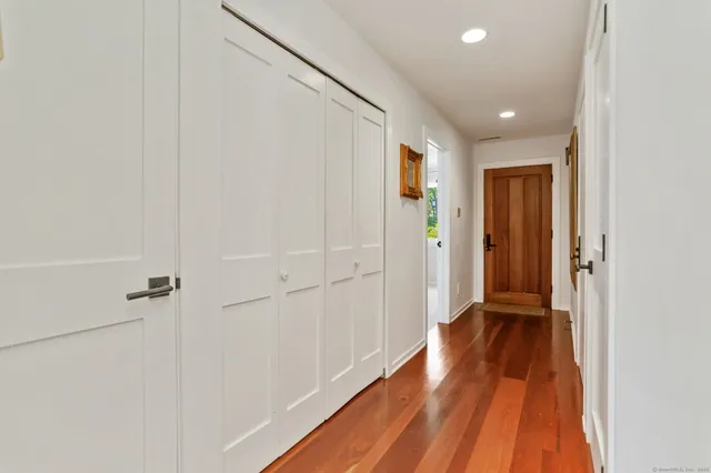 a view of a hallway with wooden floor