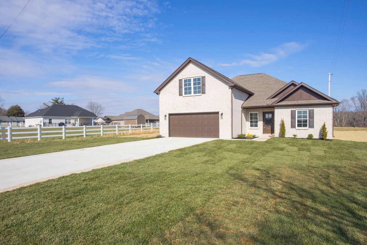 a view of house with yard and green space