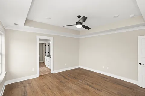 a view of empty room with wooden floor