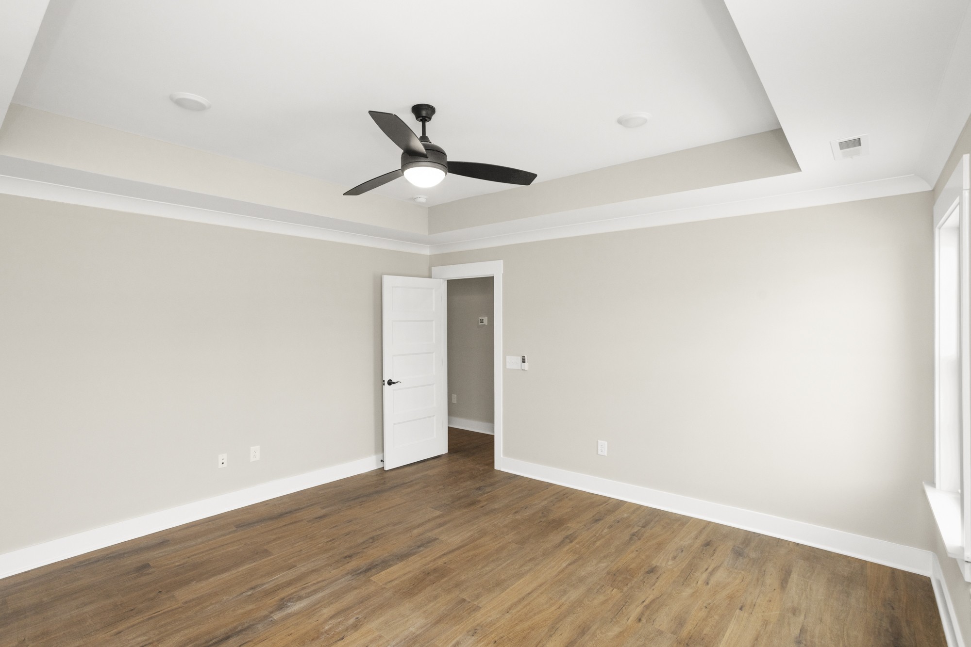 381 Copperas Creek Road Tullahoma, TN 37388 - Photo 28 of 44 a view of an empty room with wooden floor and a ceiling fan