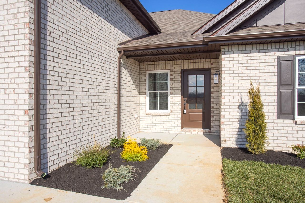 381 Copperas Creek Road Tullahoma, TN 37388 - Photo 3 of 44 a front view of a house with a garden