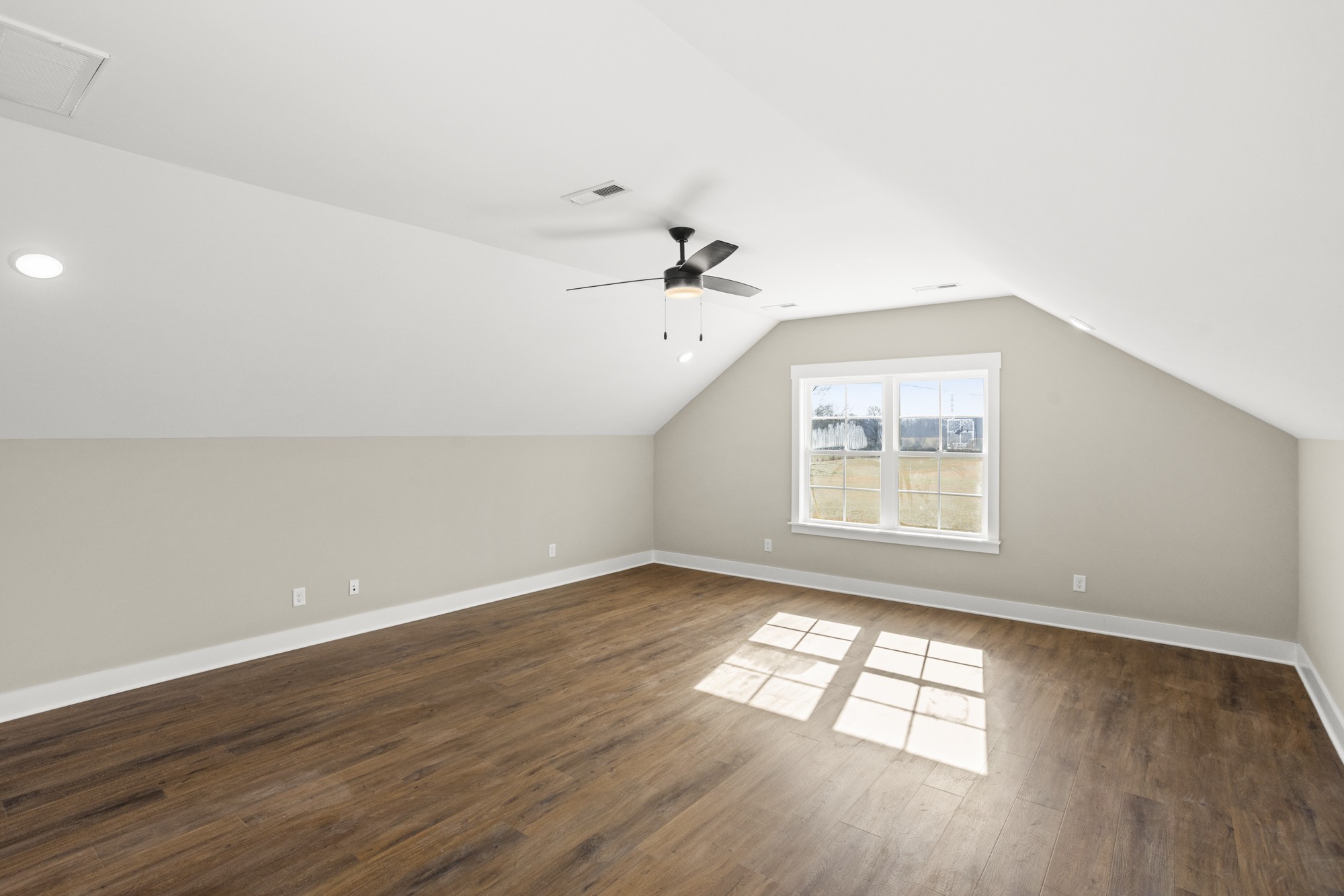 381 Copperas Creek Road Tullahoma, TN 37388 - Photo 35 of 44 an empty room with wooden floor and windows
