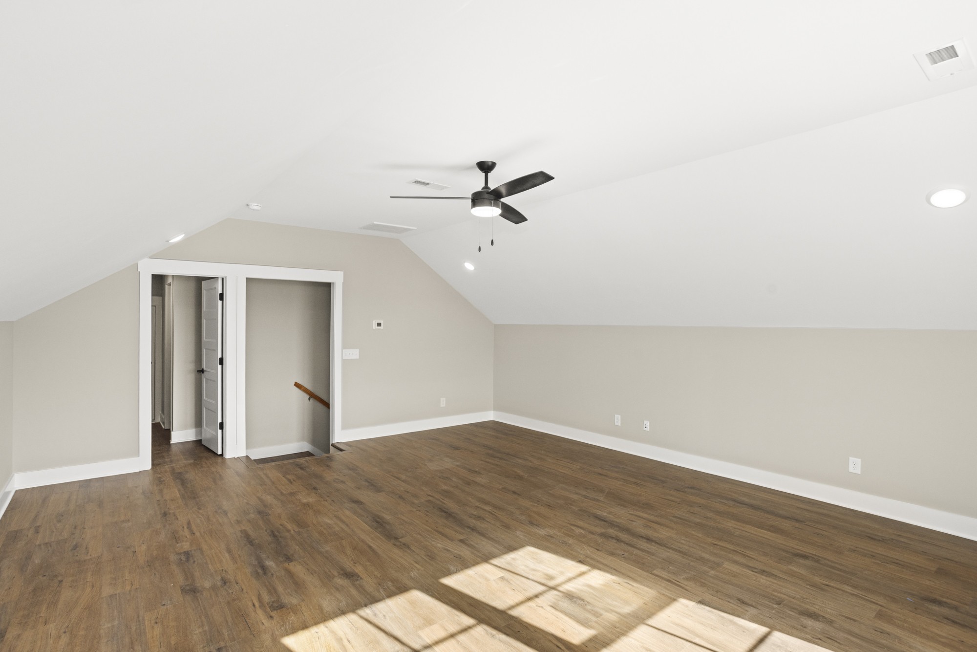 381 Copperas Creek Road Tullahoma, TN 37388 - Photo 36 of 44 an empty room with wooden floor fan and windows