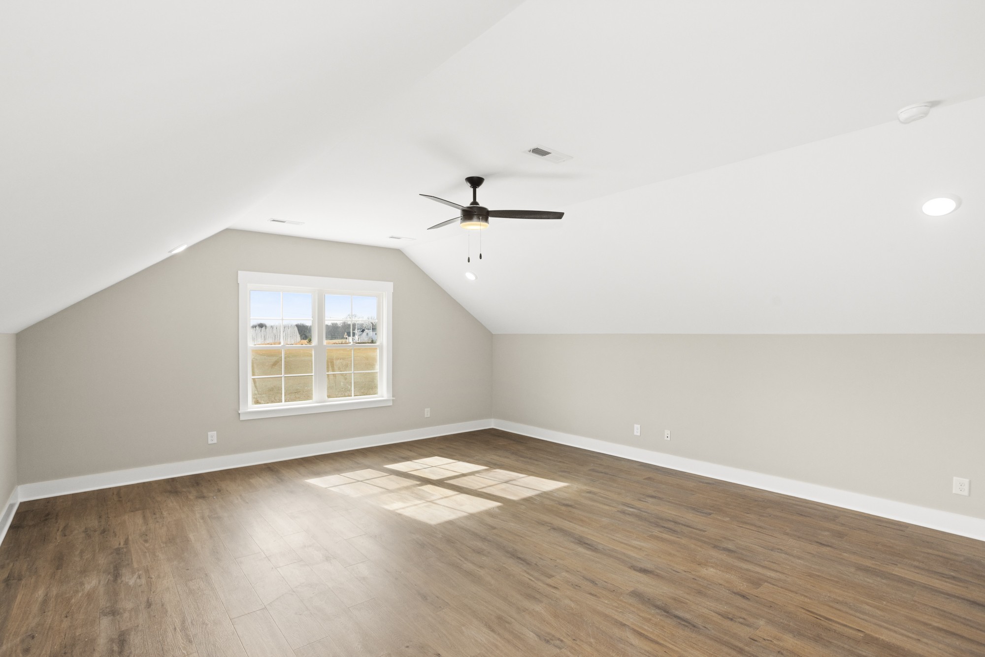 381 Copperas Creek Road Tullahoma, TN 37388 - Photo 38 of 44 an empty room with wooden floor and windows