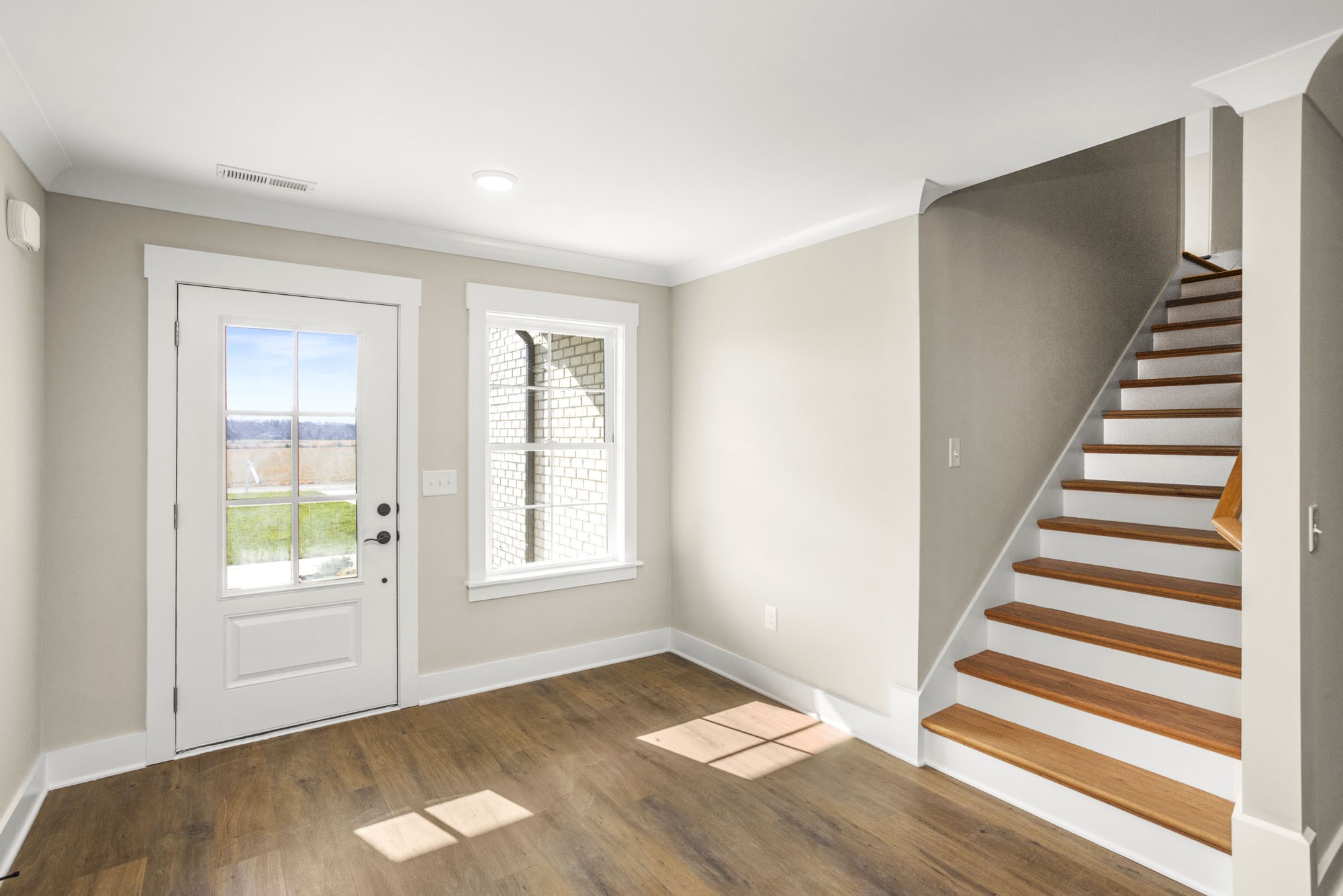381 Copperas Creek Road Tullahoma, TN 37388 - Photo 5 of 44 a view of an empty room with wooden floor and a window