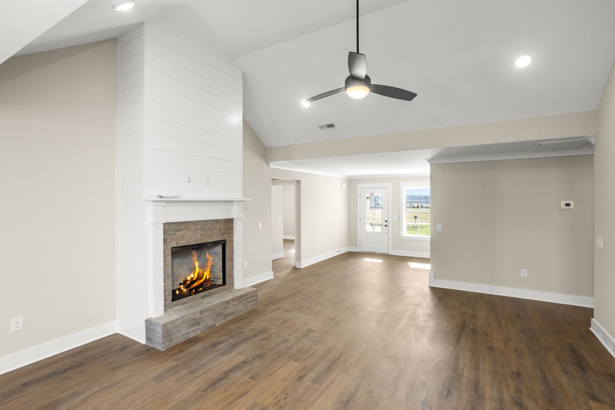 381 Copperas Creek Road Tullahoma, TN 37388 - Photo 7 of 44 a view of an empty room with wooden floor fireplace and a window