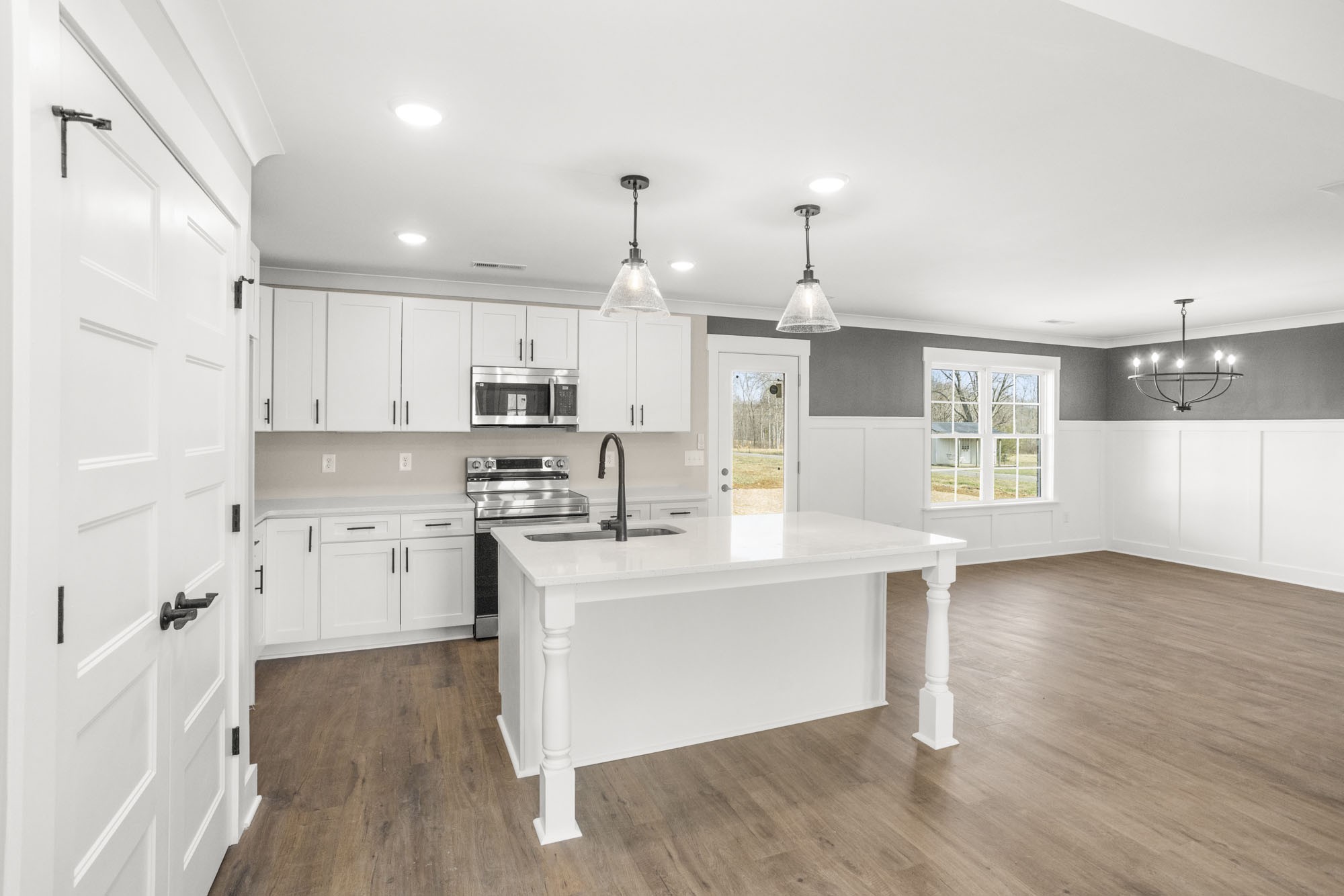 381 Copperas Creek Road Tullahoma, TN 37388 - Photo 9 of 44 a kitchen with stainless steel appliances granite countertop a sink stove and wooden floor