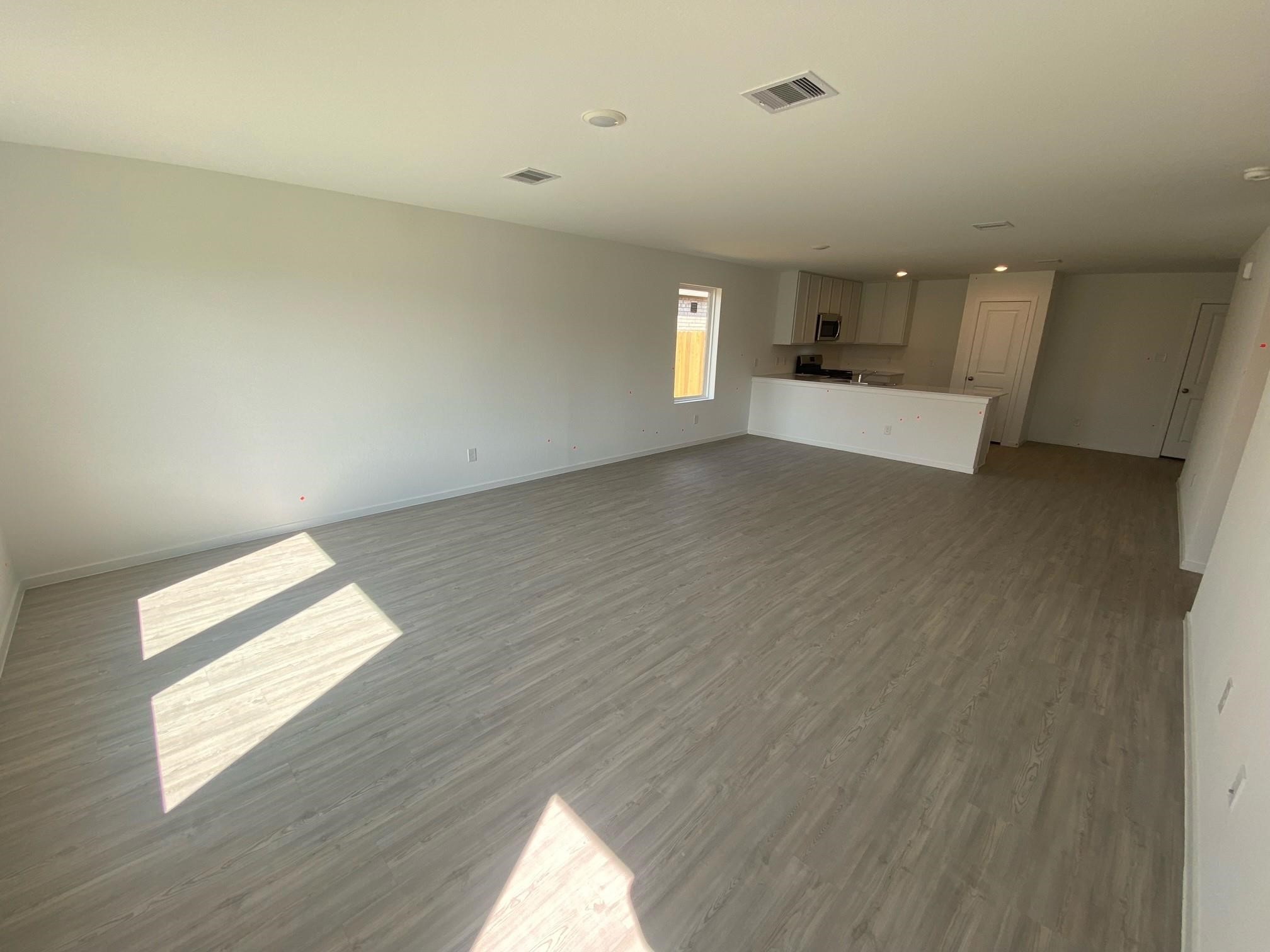 6084 Butler Ridge Drive College Station, TX 77840 - Photo 7 of 12 a view of empty room with wooden floor and window
