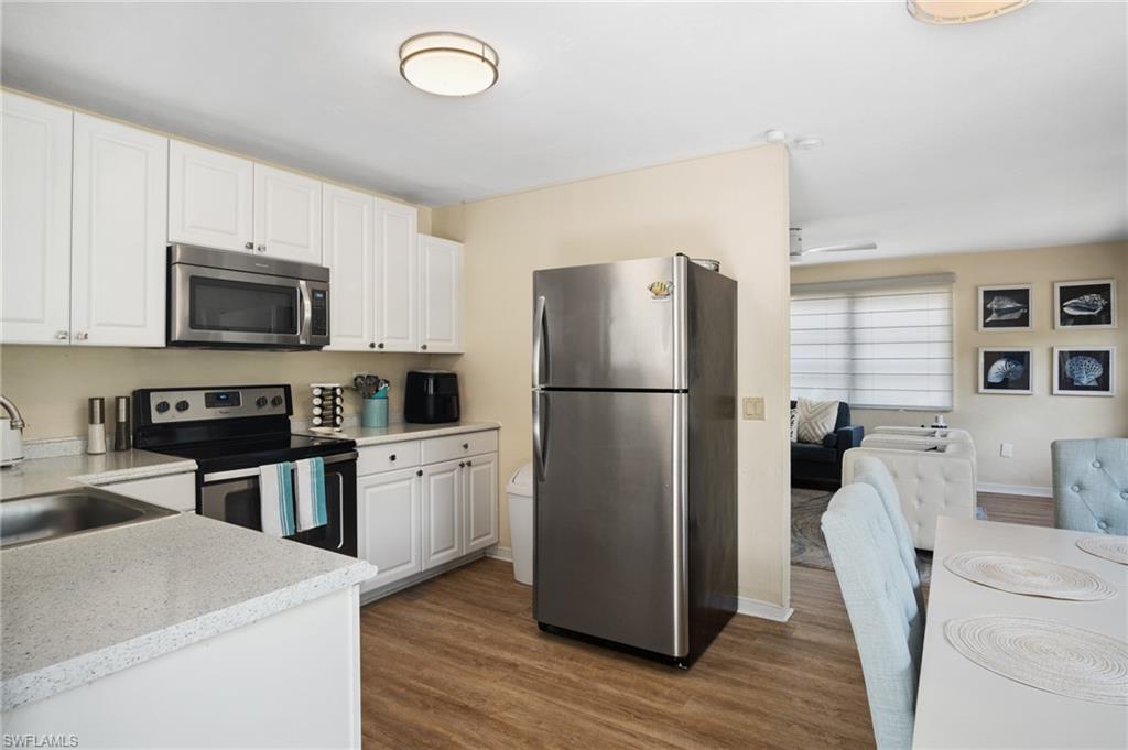1097 Sperling Avenue Naples, FL 34103 - Photo 14 of 37 a kitchen with a refrigerator a stove top oven a sink and dishwasher