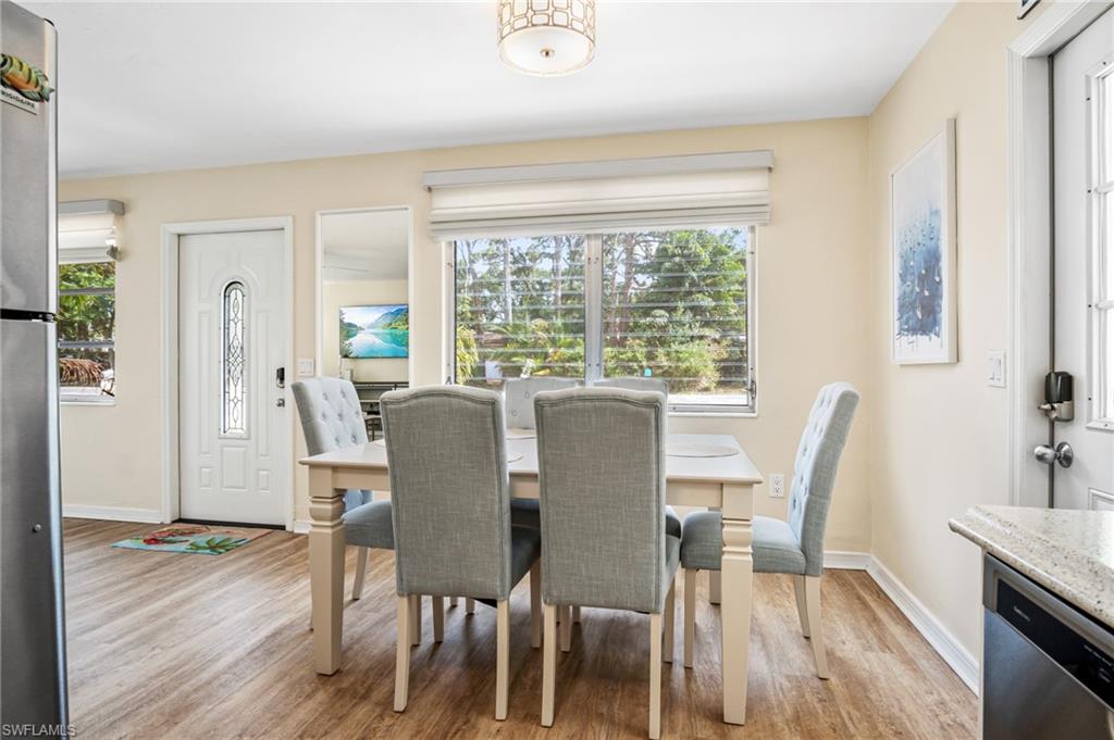 1097 Sperling Avenue Naples, FL 34103 - Photo 15 of 37 a view of a dining room with furniture window and wooden floor