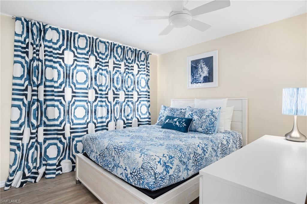 1097 Sperling Avenue Naples, FL 34103 - Photo 19 of 37 a bedroom with a bed and a table in it