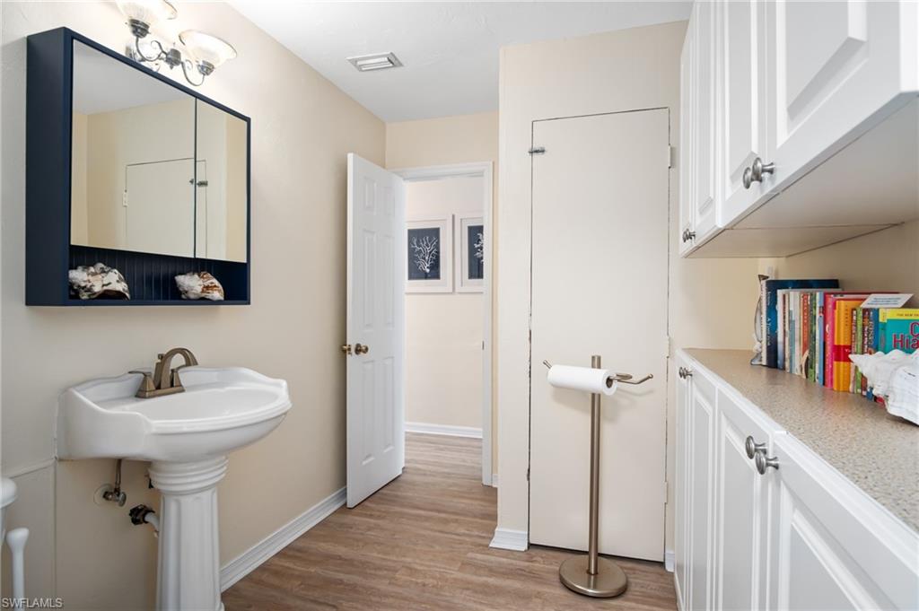 1097 Sperling Avenue Naples, FL 34103 - Photo 21 of 37 a bathroom with a sink and a mirror