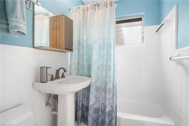 a bathroom with a sink a mirror and a bathtub