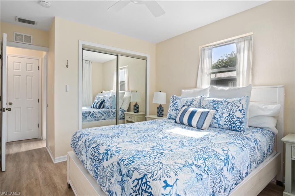 1097 Sperling Avenue Naples, FL 34103 - Photo 25 of 37 a bedroom with a large bed and a chandelier