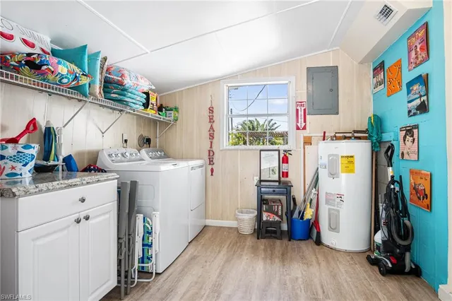 a utility room with fridge dryer and washer