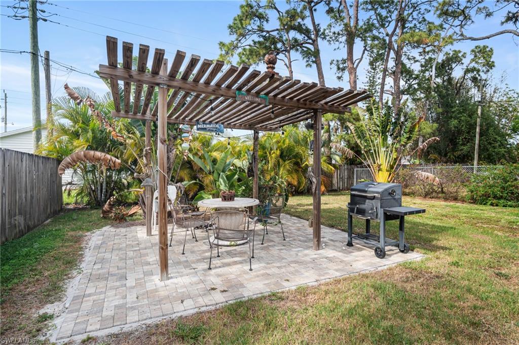 1097 Sperling Avenue Naples, FL 34103 - Photo 32 of 37 a view of chairs and table in backyard